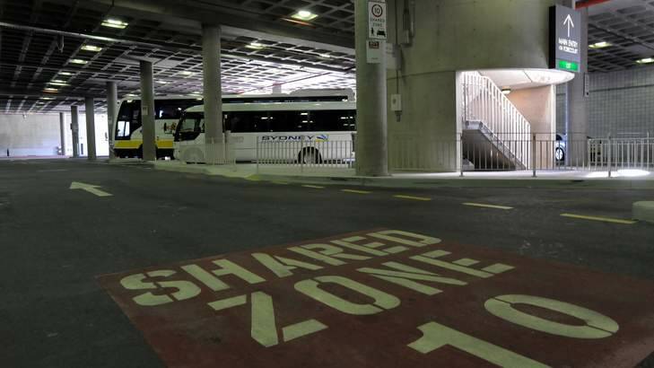 Buses parked in the main underground public car park at Parliament House. Photo: Graham Tidy