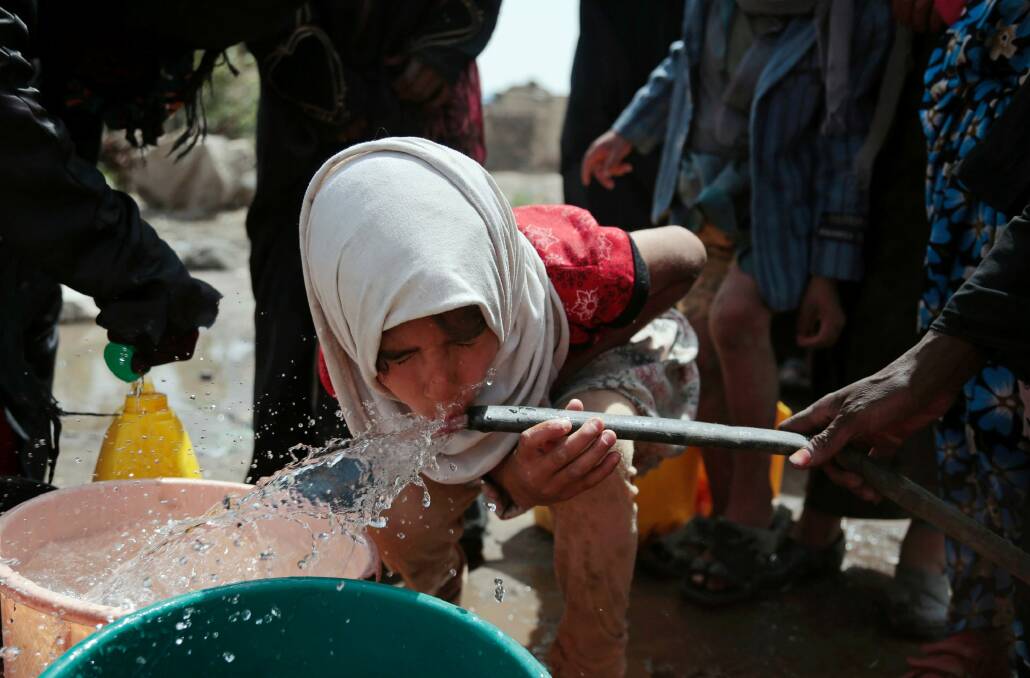 A girl drinks water from a well that is allegedly contaminated with cholera bacteria, on the outskirts of Sana'a. Photo: AP