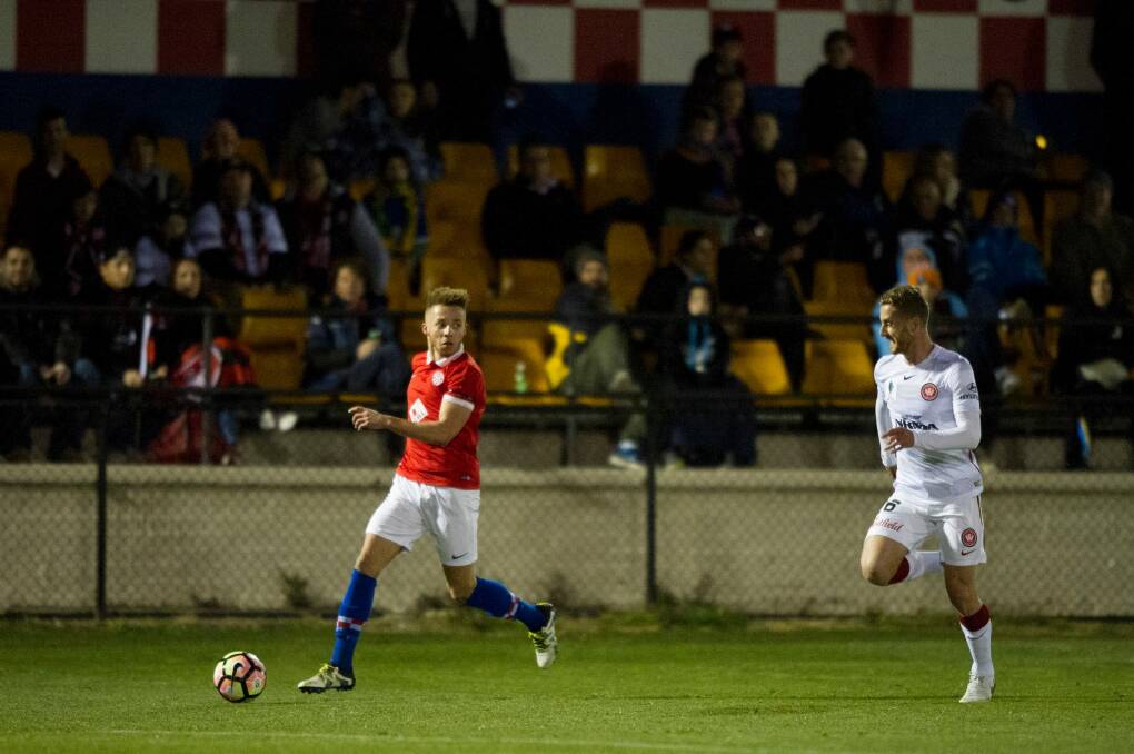 Canberra FC's Thomas James sets up a cross against the Wanderers on Wednesday night. Photo: Jay Cronan
