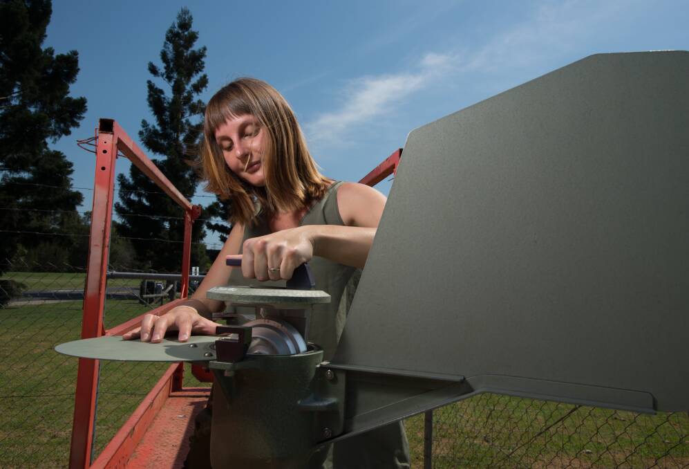 QUT researcher Dr Andelija Milic removes the pollen drum from the pollen trap at Rocklea in Brisbane's south. Photo: QUT