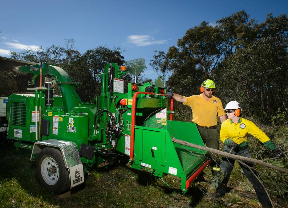 Seasonal fire crews use a chipper in their bid to reduce the fire hazard in Bruce bushland. Photo: Sitthixay Ditthavong