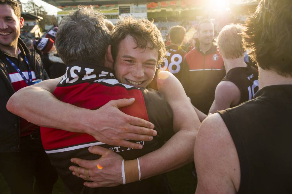 Joshua Taylor hugs Coach Chris Rourke after winning the grand final. Photo: Dion Georgopoulos