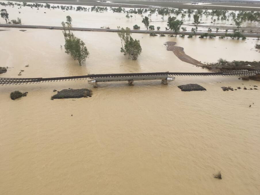 Aerial view of the Mount Isa rail line east of Julia Creek, taken earlier this month as the flood peaked in the area. Photo: Supplied