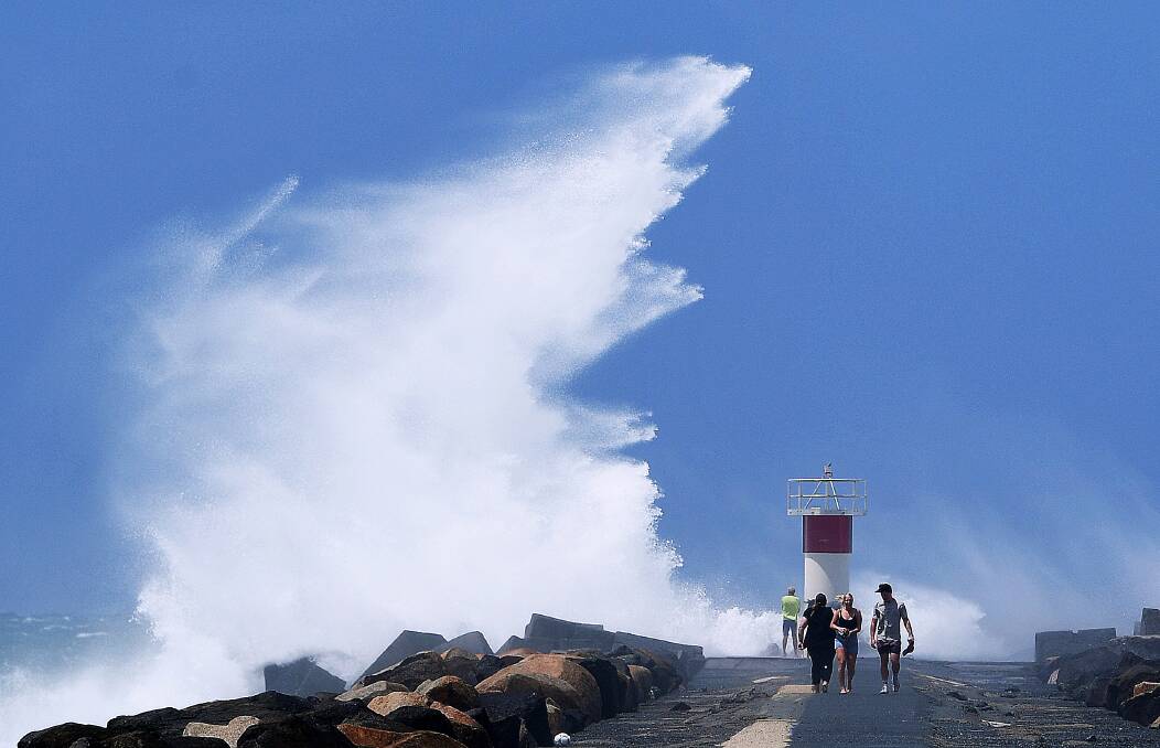A severe weather warning for damaging winds, abnormally high tides and
dangerous surf remains for parts of the coast. Photo: AAP/Dave Hunt. 