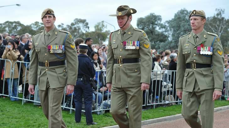 Marching are VC recipients (from left) Ben Roberts-Smith, Daniel Keighran and Mark Donaldson. Photo: Graham Tidy