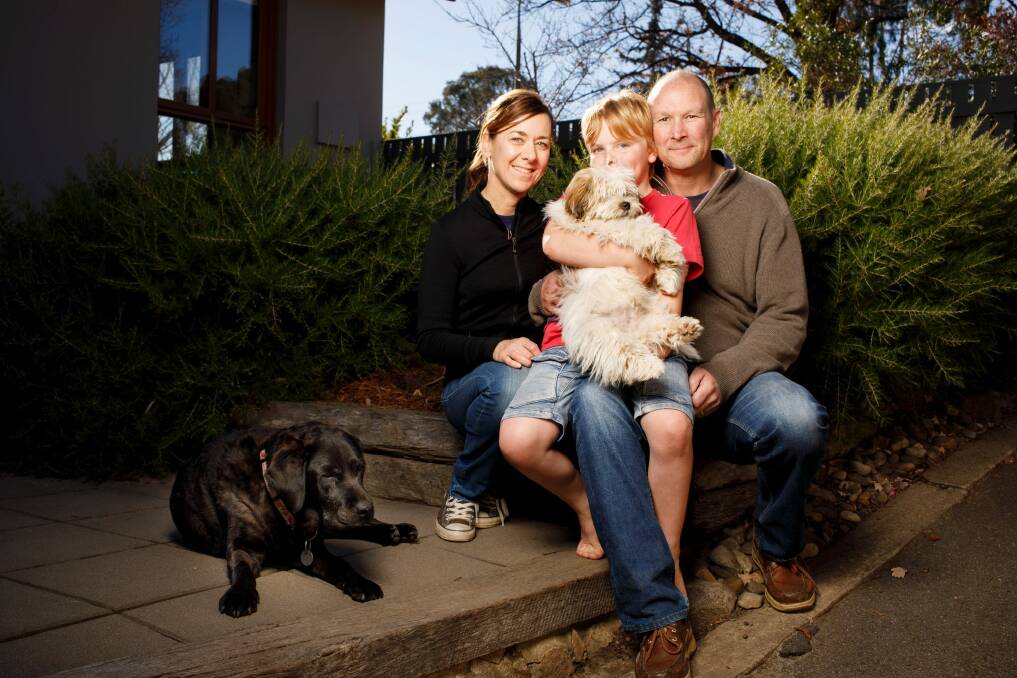Matthew, Karen and Will Owen at home in Canberra with dogs Stella and Buddy. Photo: Sitthixay Ditthavong