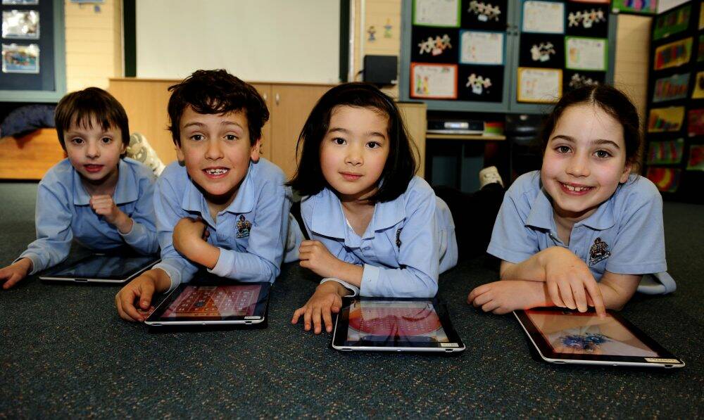 Northside Grammar School pupils, from left, Angus Hudson, Dashiell Brown-Rees, Bella Mun and Holly Irvine use iPads in class in this 2012 file photo. Photo: Melissa Adams