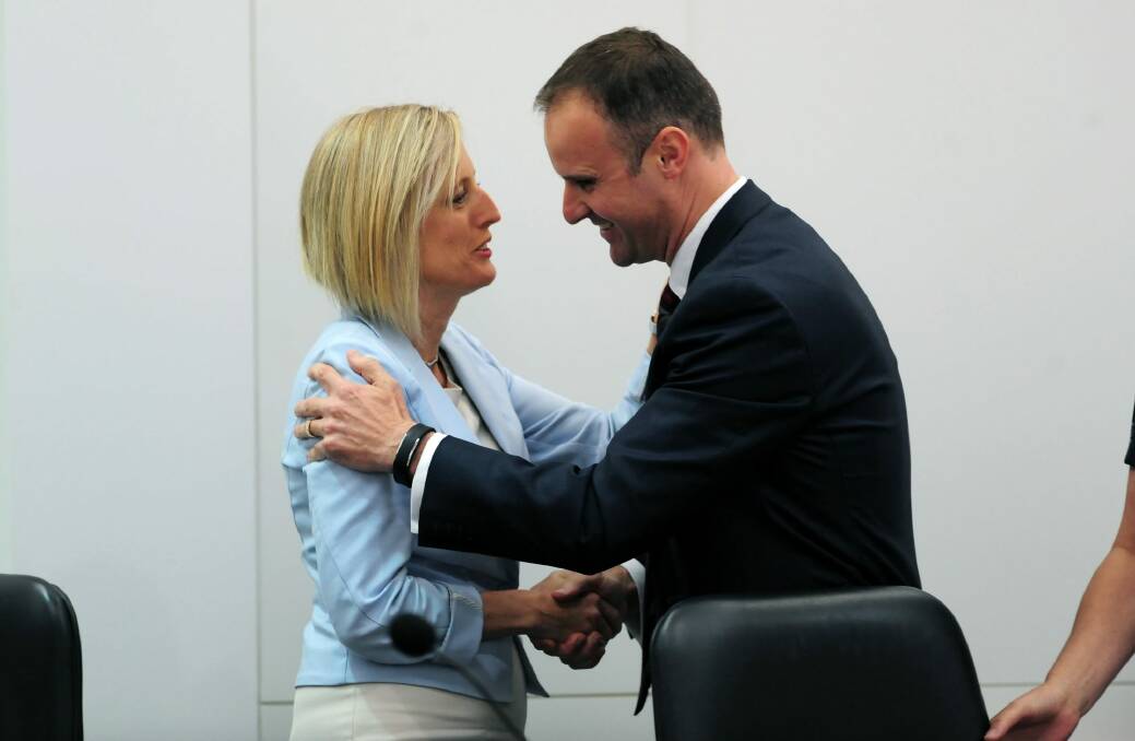 ACT Chief Minister Andrew Barr is congratulated by his predecessor Katy Gallagher. Photo: Graham Tidy