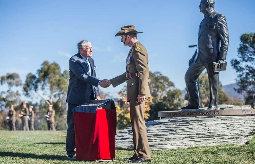 Australian War Memorial Council chair Kerry Stokes and Chief of Army Lieutenant General Rick Burr unveil the plaque beside a commemorative sculpture of General Sir John Monash. Photo: Karleen Minney