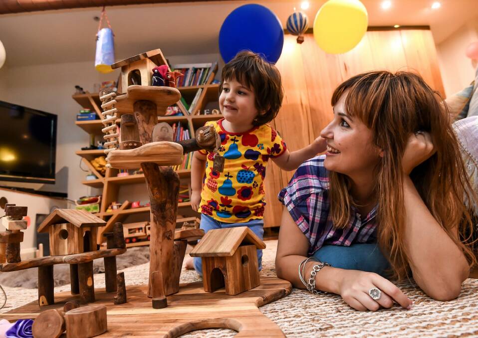 Three-year-old Leo Colosimo having fun with some traditional toys as mum Kristy Biagini looks on. Photo: Justin McManus