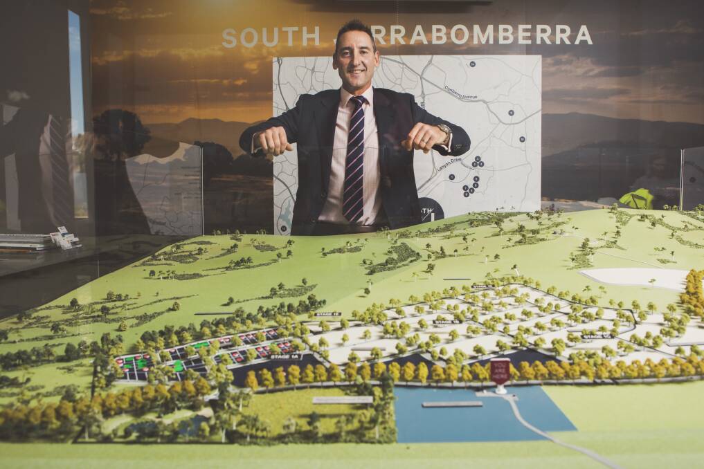 Village Building Co. chief executive Travis Doherty with a model of the master plan for the 1250-home estate. Photo: Jamila Toderas