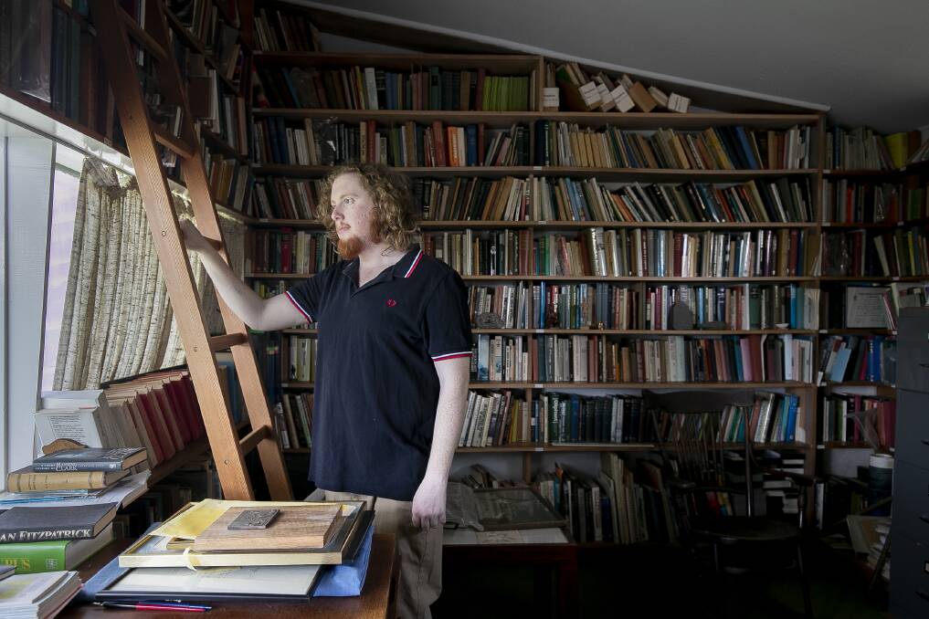 James Henshaw, 21, is looking after Manning Clark House over the summer break. He is pictured here in the study. Photo: Sitthixay Ditthavong