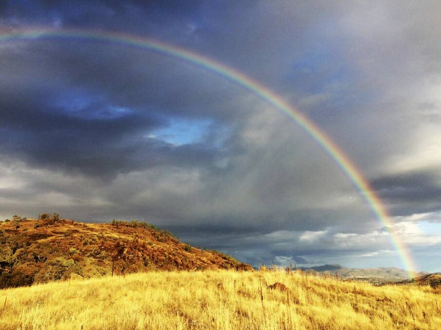 After the rain: This rainbow was captured over Tuggeranong from Coolamon Ridge. Photo: Chris Appleton