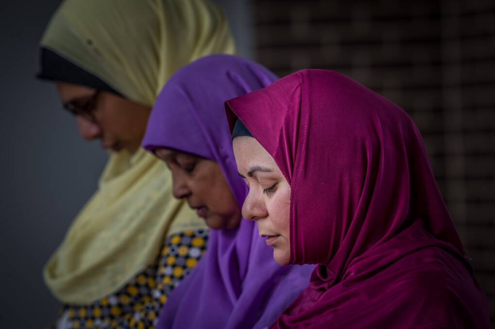 Muslim women Mai Shouman, Meherun Nisa and
Rita Joyan pray at Gungahlin Mosque on Saturday afternoon, after terror attacks at mosques in New Zealand on Friday. Photo: Karleen Minney