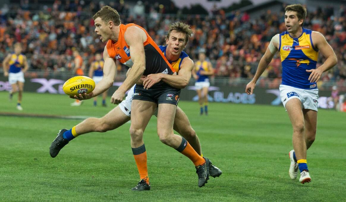 Tagged: Luke Partington of the Eagles tackles Heath Shaw. Photo: AAP