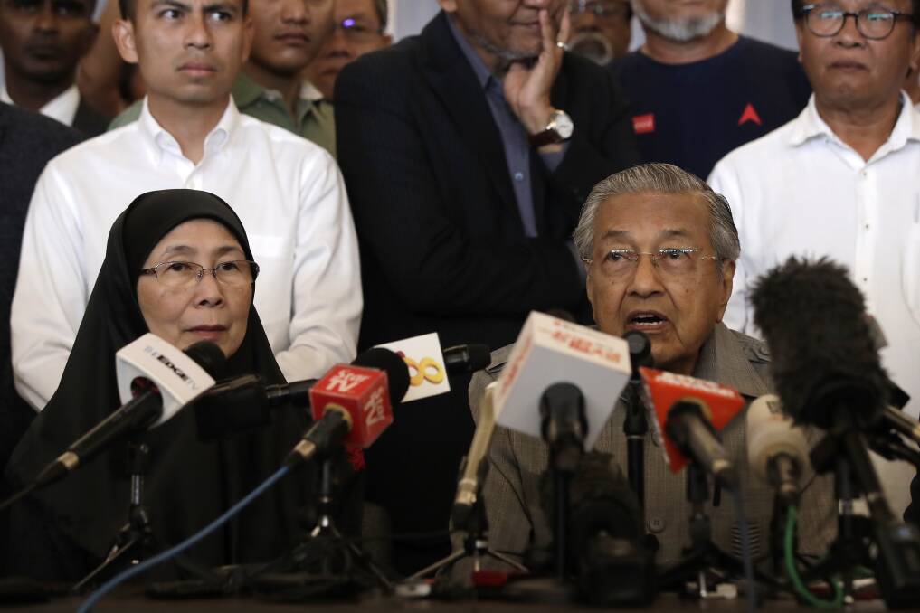 Mahathir Mohamad, with Justice Party president Wan Azizah, calls for the right to form government. Photo: AP