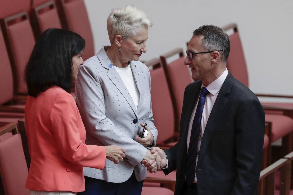 Crossbench MPs Julia Banks and Kerryn Phelps shake hands with Greens leader Richard Di Natale after the Senate agreed on House's amendments to its amendments to the Home Affairs Legislation Amendment Bill. Photo: Alex Ellinghausen