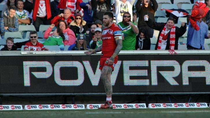 Former Raiders player Josh Dugan gets a varied reaction from the crowd after scoring a try. Photo: Graham Tidy