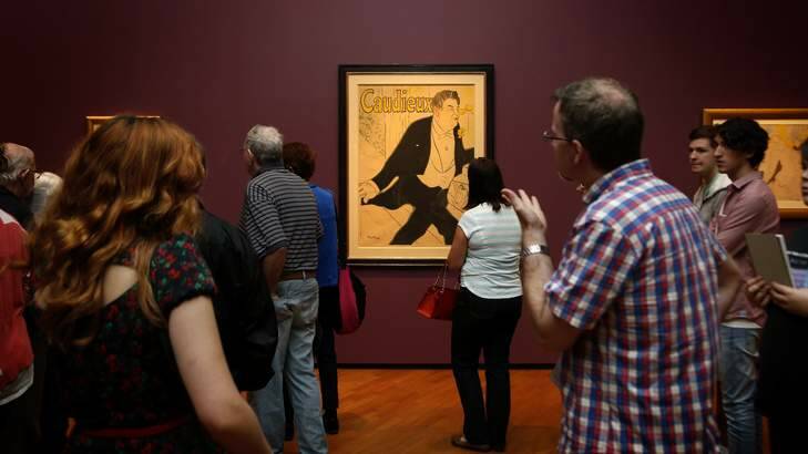 Visitors to the National Gallery of Australia look at the work Caudieux during Toulouse Lautrec exhibition. Photo: Jeffrey Chan