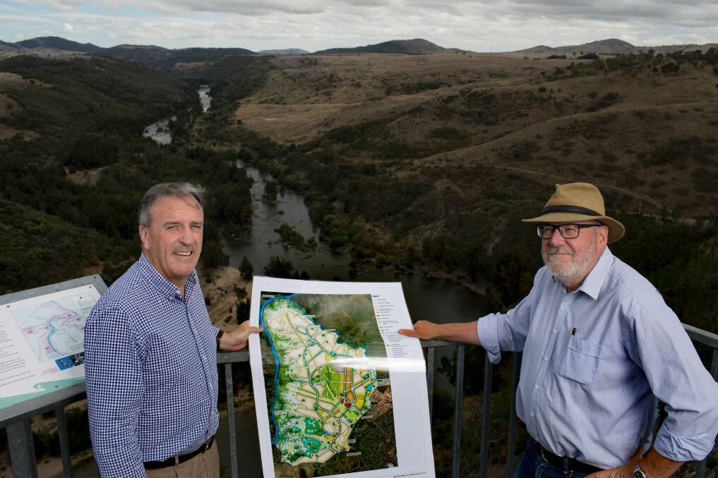 Riverview director David Maxwell and planning consultant Tony Adam at Shepherds Lookout, overlooking the Murrumbidgee River. The plateau to the right is the edge of the planned suburban development. Photo: Sitthixay Ditthavong