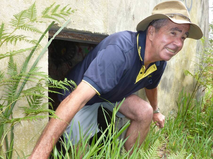 Richard Fisher emerges from a World War II bunker at Burrewarra Point, near Broulee. Photo: Tim the Yowie Man