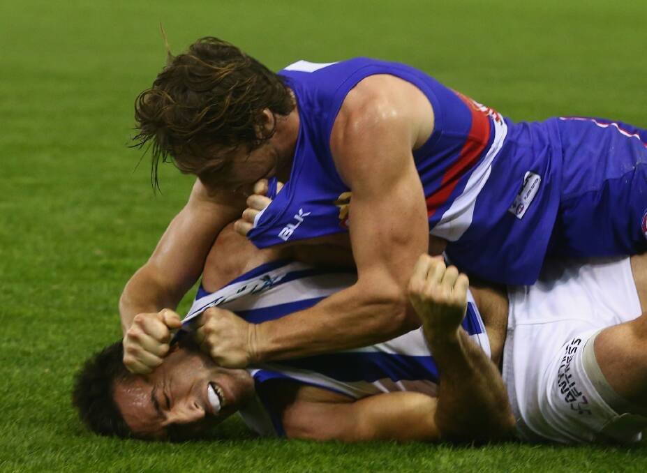 Getting to grips with each other: Liam Picken of the Bulldogs and Michael Firrito of the Kangaroos indulge in a spot of wrestling. Photo: Getty Images