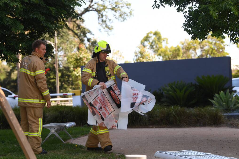 A firefighter is seen carrying a hazardous material bag into the South Korean consulate in Melbourne on Wednesday. Photo: AAP
