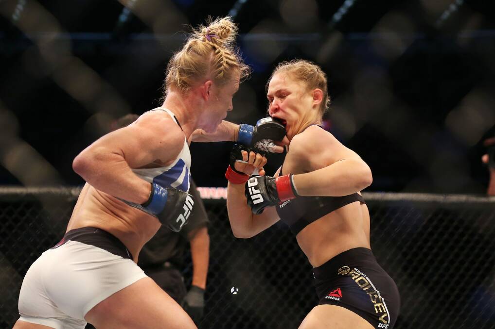 Holly Holm lands one on the face of Ronda Rousey in their UFC title fight last Sunday in Melbourne.  Photo: Getty Images
