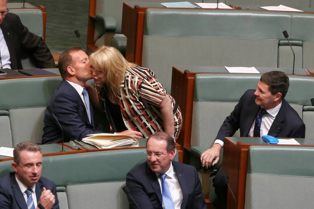 Former prime minister Tony Abbott is greeted by colleague Natasha Griggs as they take their seats on the backbench for question time last month. Photo: Alex Ellinghausen