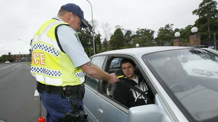 Snr Constable Adam Kite of Wollongong highway patrol Tests a driver. Photo: David Tease