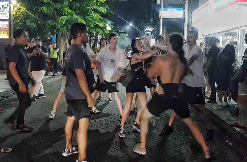 Schoolies push each other after one of the girls was hit in Bali. Photo: Amilia Rosa