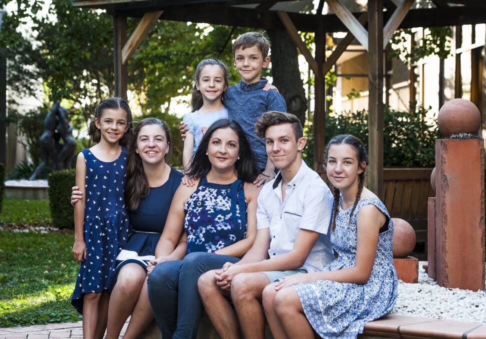 Kate Seselja (front row, centre) with children (from left) Hope, 9, Isabelle, 15, Zoe, 5, Jonah, 8, Ethan, 17, and Lily, 13. Photo: Elesa Kurtz