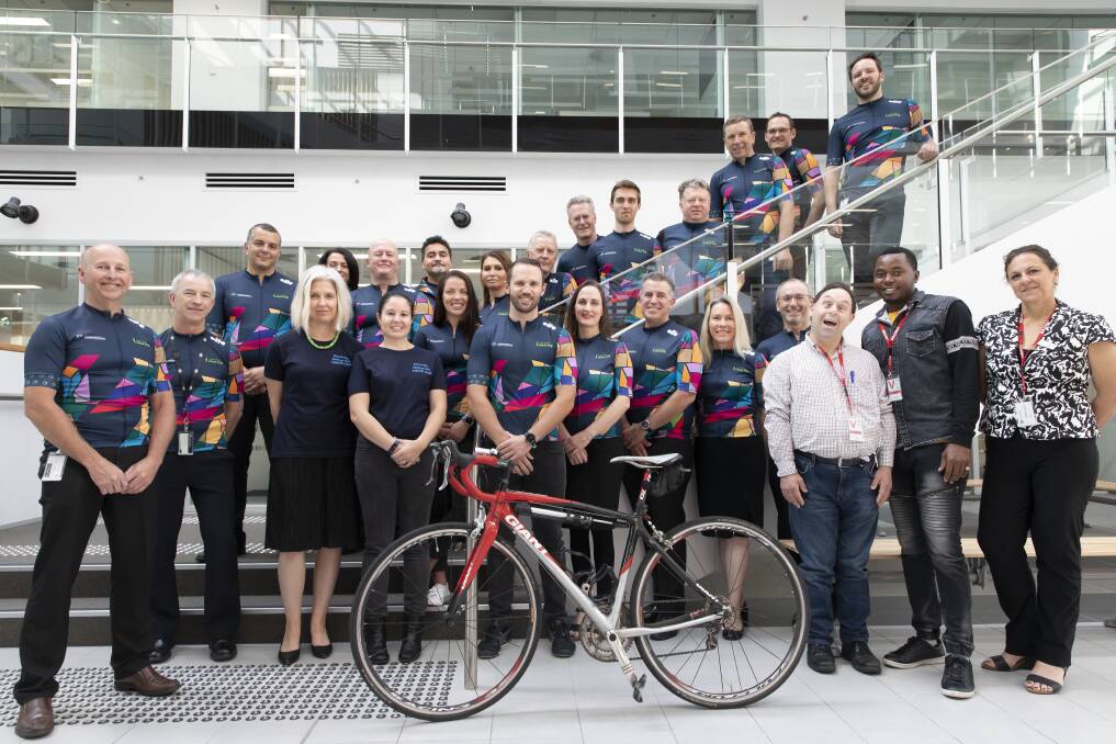 The Department of Human Services’ Hartley Lifecare Cycle Challenge Team with Harley Lifecare client Richard Smith (bottom, third from right).  Photo: Sitthixay Ditthavong