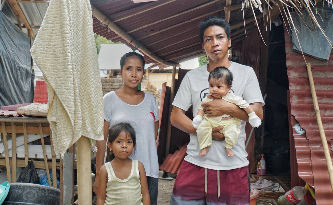 Hanan and his family next to their temporary house.
 Photo: Amilia Rosa