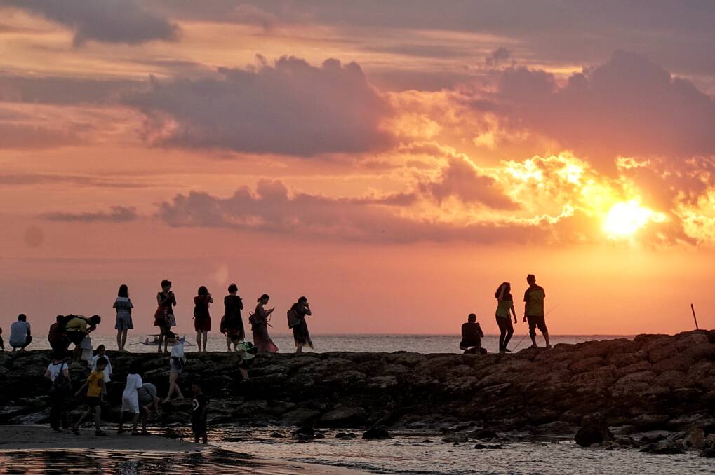 Chinese tourists watch the sunset in Kuta. Photo: Amilia Rosa