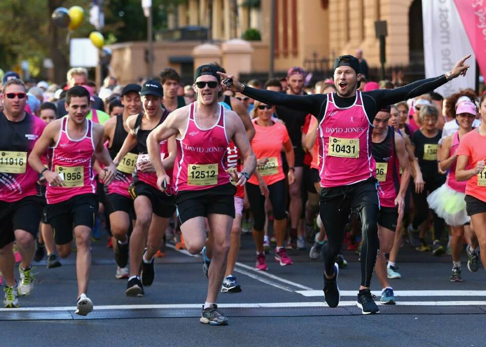 Canberra's Mick Spencer (centre, to the left of Jason Dundas, who has arms stretched out) completing a half-marathon for charity. Mick has two serious heart conditions but competes in sports where he can exert some control over his heart rate. Photo: supplied