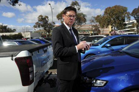 Director of Transport Regulations with ACT Justice and Community Safety, David Snowden, with one of the new hand-held devices used by parking inspectors to record infringements.  Photo: Graham Tidy