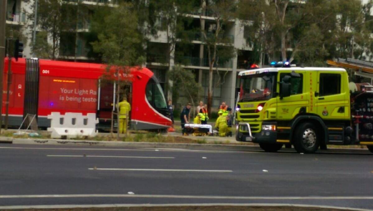 Emergency services tend to a pedestrian after they were hit by a tram on Canberra's light rail network. Photo: Katie Burgess