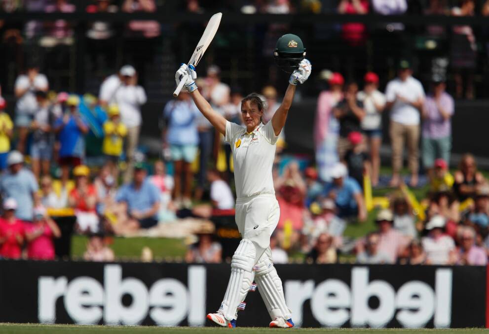Cracking knock: Ellyse Perry salutes the crowd after reaching triple figures. Photo: AAP