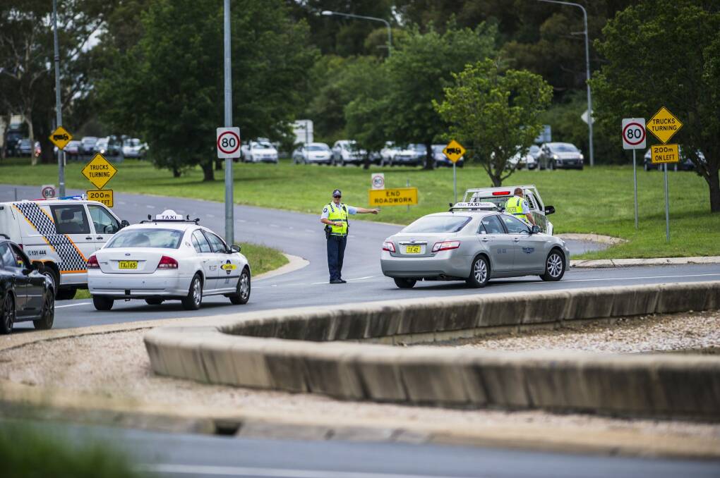  Police block off Parkes Way (going towards Queanbeyan) and Anzac Parade, due to a car crash and car fire on Wednesday afternoon. Photo: Jamila Toderas