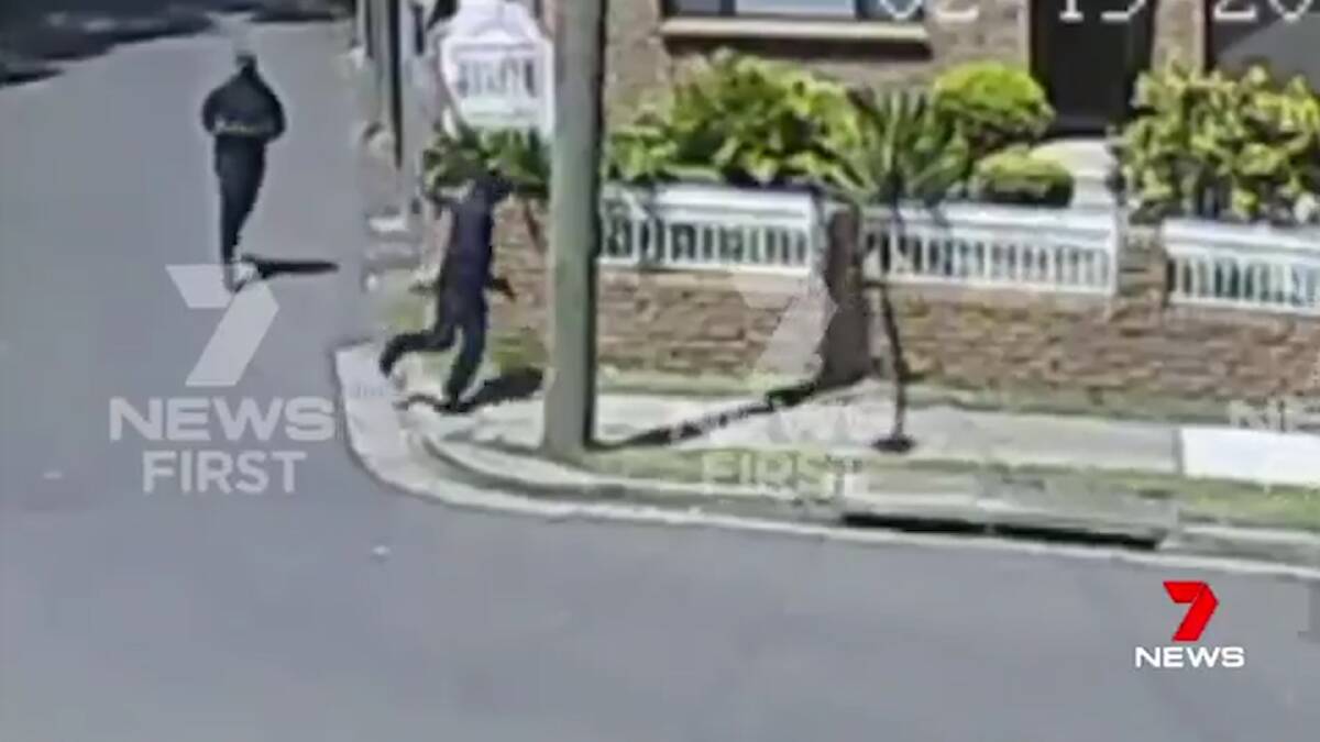 Two men running from the scene of a burning car that could be connected with the shooting. Photo: Seven News