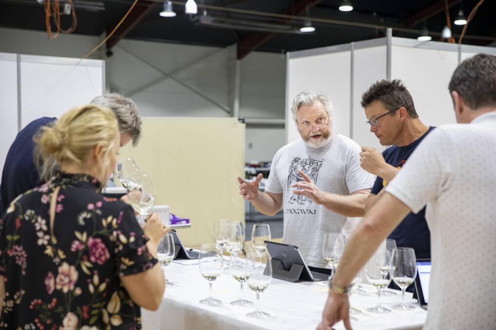 Chairman of judges David Bicknell confers with judges at the National Wine Show. Photo: Sitthixay Ditthavong