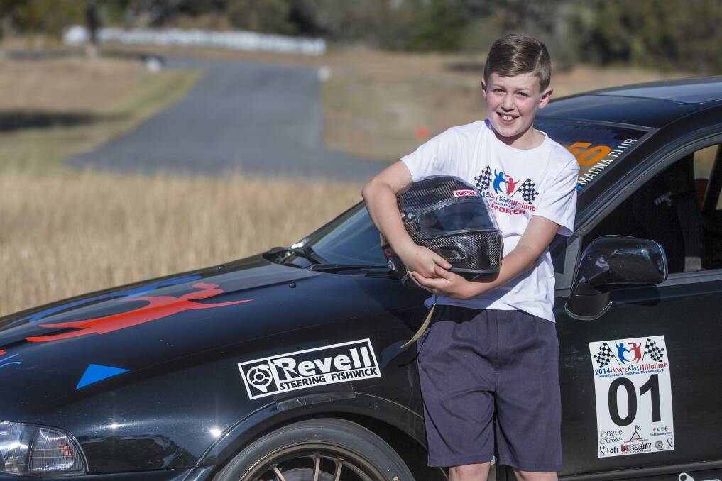 Thomas Henderson-Smith,10, with HeartKids hillclimb organiser Dan Cummin's race car. Photo: Matt Bedford