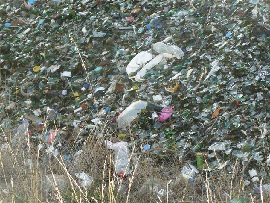 Plastic and other rubbish is mixed up in the unwashed recycled glass. Photo: Supplied