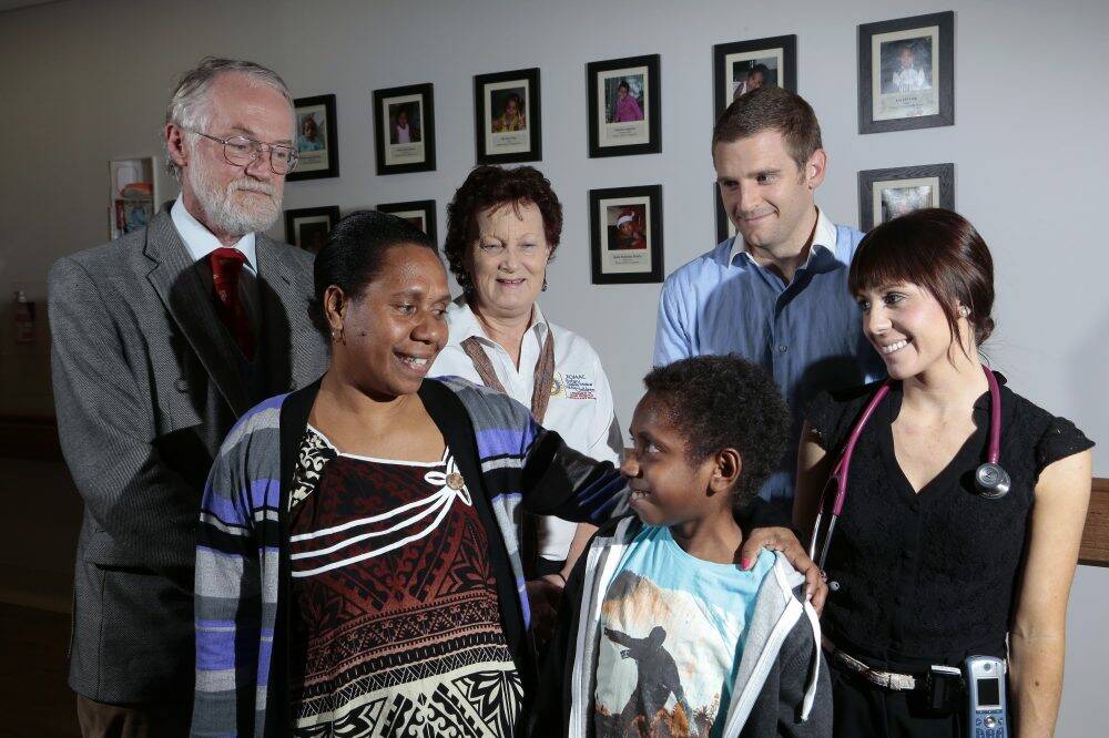 Reedly Gershon with his mother, Juliette, and  his team,  from left, paediatric surgeon  David Croaker, ROMAC host  Sandra Mahlberg, paediatric surgeon registar Liam Quinn and paediatric surgeon resident Erin O'Reilly. Photo: Jeffrey Chan