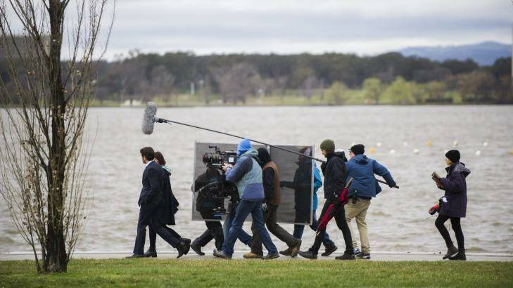 <i>The Code</i> film crew and actors had to battle the weather in Canberra on Monday afternoon. Photo: Rohan Thomson