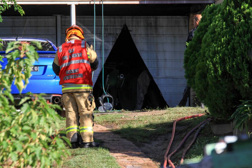 Firefighters had to cut their way into the garage. Photo: Jorge Branco/Fairfax Media.