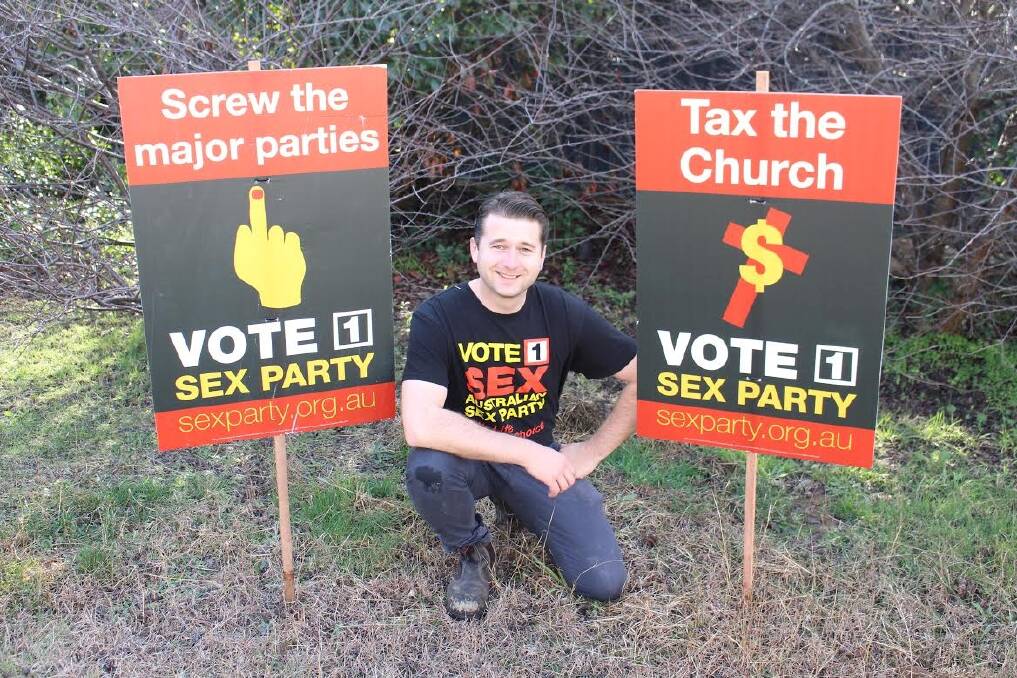 Steven Bailey with the "offensive" Sex Party corflutes. Photo: Supplied