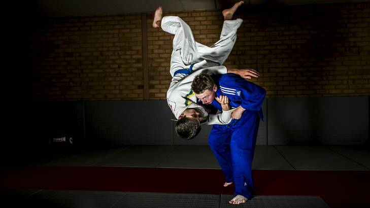 Samuel Dobb, 14, in blue, has been selected to represent Australia in Judo at the Youth Olympics. Photo: ROHAN THOMSON