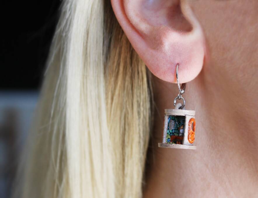 The earrings even feature tiny graffiti walls on the inside. Photo: Suitcase Dollhouse